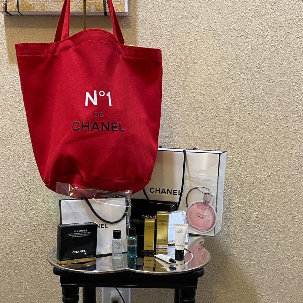 CHANEL No.1 Red Tote with numerous products and bags.